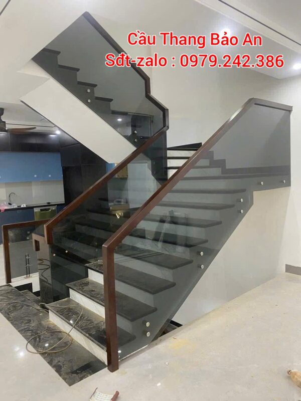 CẦU THANG KÍNH TAY VỊN GỖ . CẦU THANG LAN CAN KÍNH XÁM KHÓI